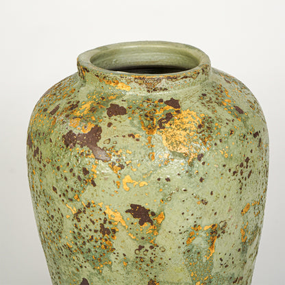 Closeup image of green ceramic decorative vase for modern tabletop decor styling with rustic textured finish.