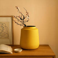 Yellow metal textured vase placed in a warm modern room adding a bold elegant accent to living room tables and corner spaces.