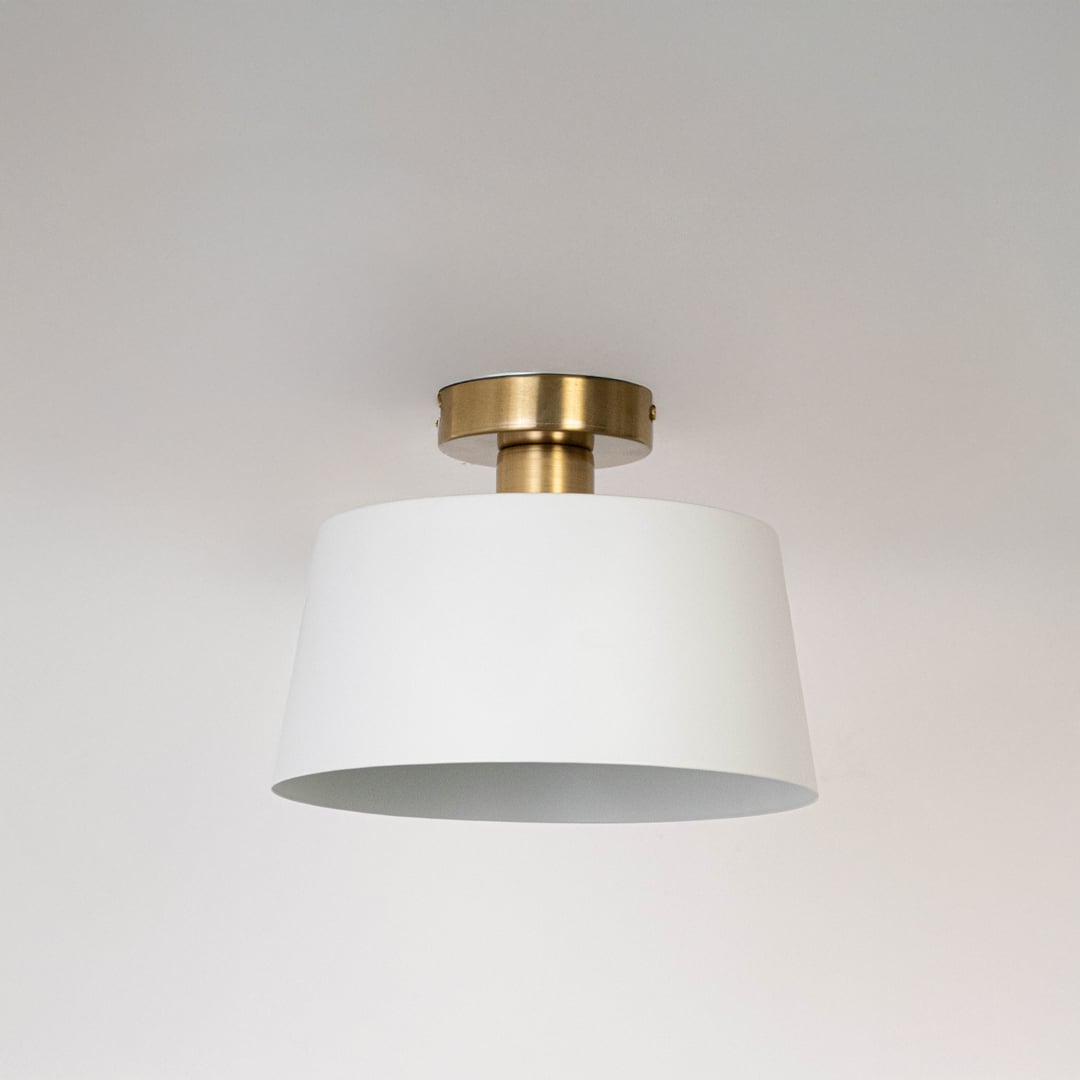 White semi flush ceiling light with gold holder shown off elegant dome style fixture for bedroom and hallway ceiling lighting.