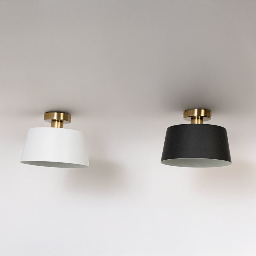 Black and white ceiling lights with gold fittings and drum shades in off mode on white background for modern ceiling decor.