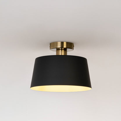 Modern black metal ceiling light with warm ambient glow for stylish bedroom and contemporary decor styling spaces.
