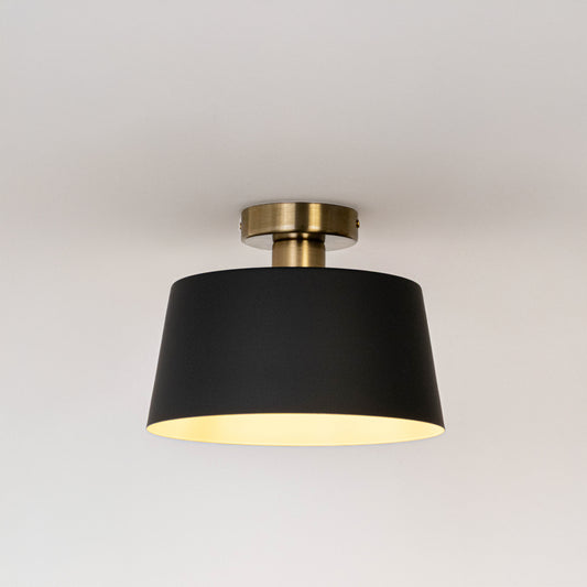 Modern black metal ceiling light with warm ambient glow for stylish bedroom and contemporary decor styling spaces.