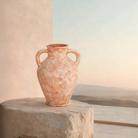 Lifestyle image of peach ceramic handle vase for modern outdoor decor styling with rustic textured finish.