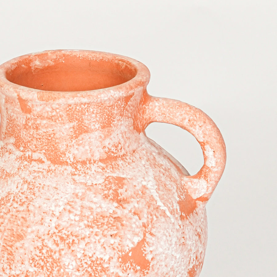 Closeup image of peach ceramic handle vase for modern tabletop decor styling with rustic textured finish.
