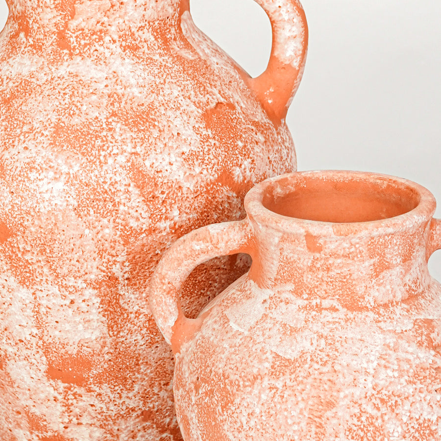 Closeup image of peach ceramic decorative vase set for modern living room styling with textured finish.