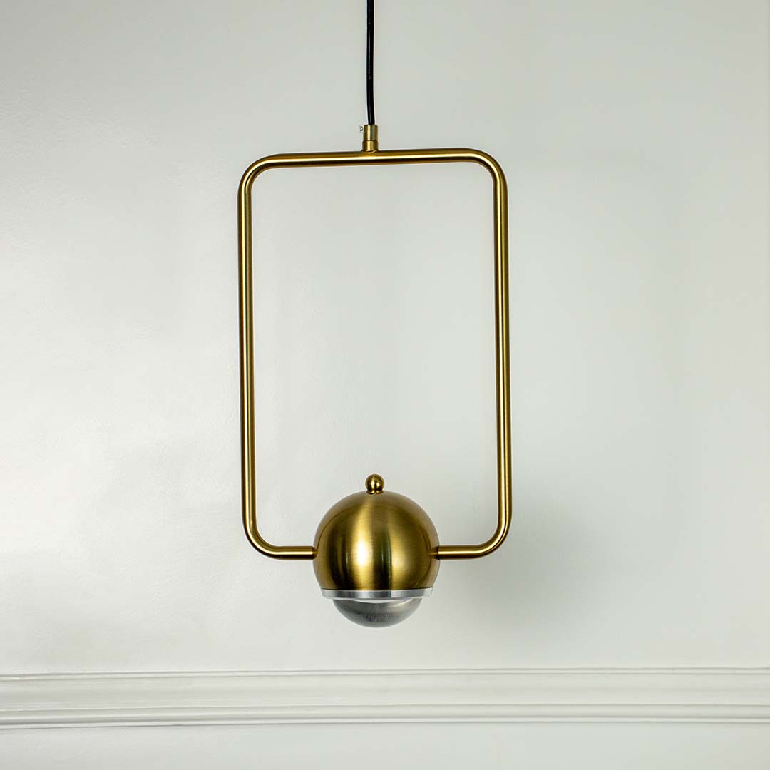 Gold metal pendant light with geometric square frame crafted for modern living spaces.