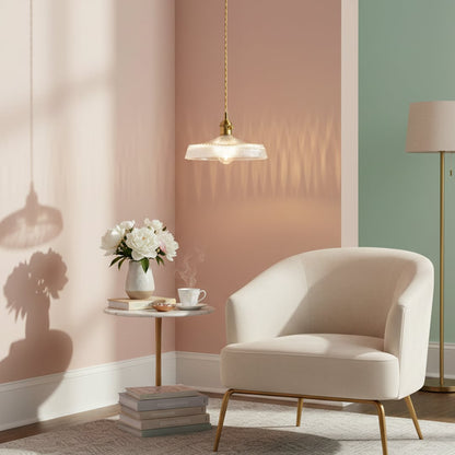 Clear textured glass pendant light with gold accents illuminating elegant living room decor with warm charm.