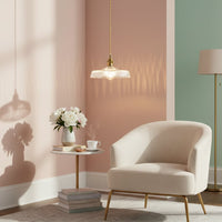 Clear textured glass pendant light with gold accents illuminating elegant living room decor with warm charm.