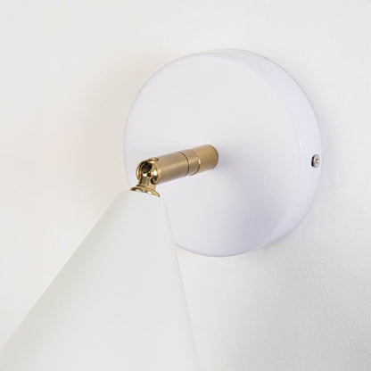 Closeup view of white metal wall sconce highlighting its conical shade smooth matte finish and warm lighting design suited for modern interior decor.