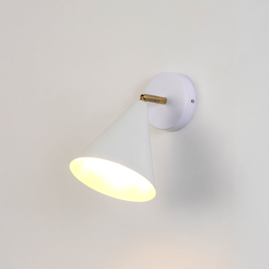 White metal wall light with dome shade and gold holder emitting warm glow ideal for bedroom or hallway wall decor placement.
