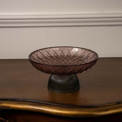 Modern smoky brown glass bowl with criss-cross embossed pattern and dark ribbed pedestal base on a plain white backdrop.