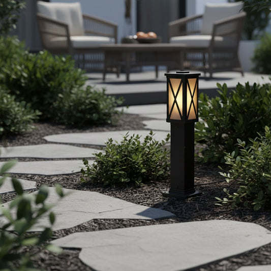 Elegant black pillar light with X design and frosted glass styled beside garden pathway for outdoor lighting decor.