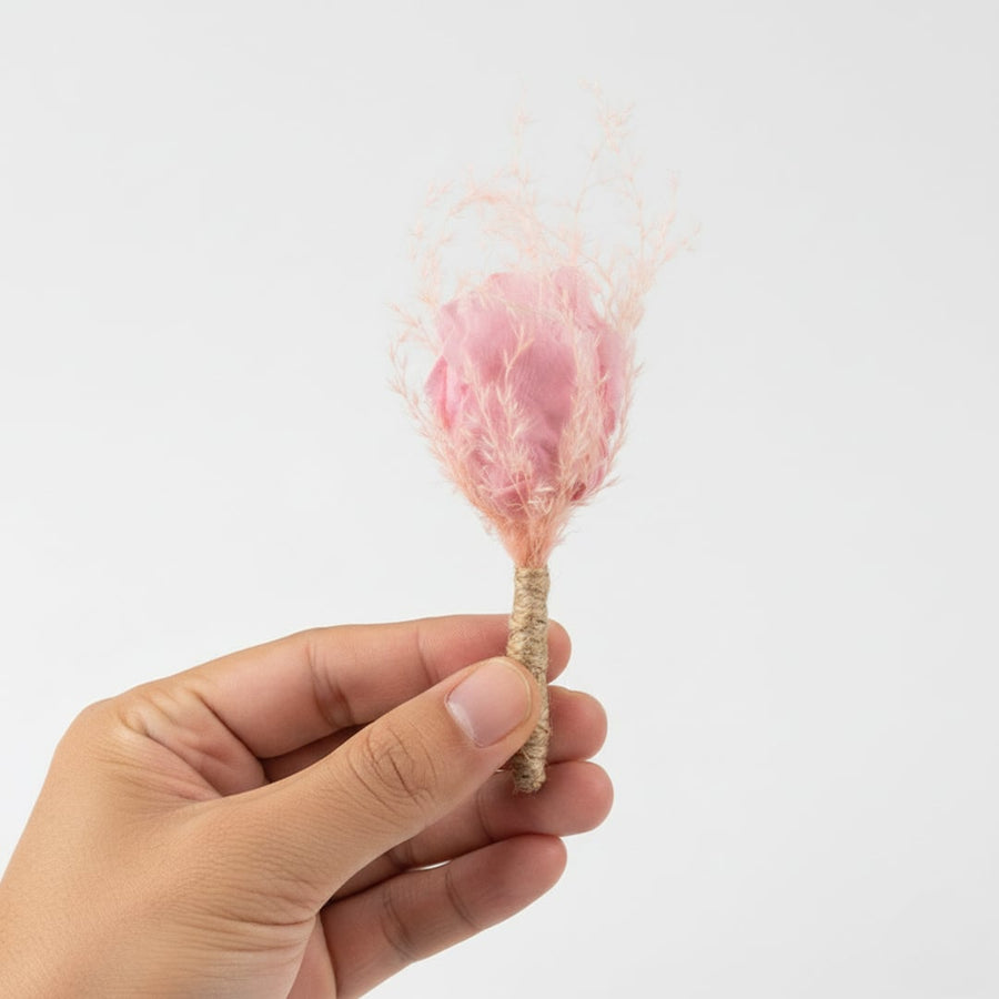 Minimal dried floral stem with soft pink preserved grass held in hand suited for modern decor gifting and styling accents.