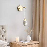 Gold crystal wall light glowing beside sofa in modern living room for elegant home interior wall lighting decor.