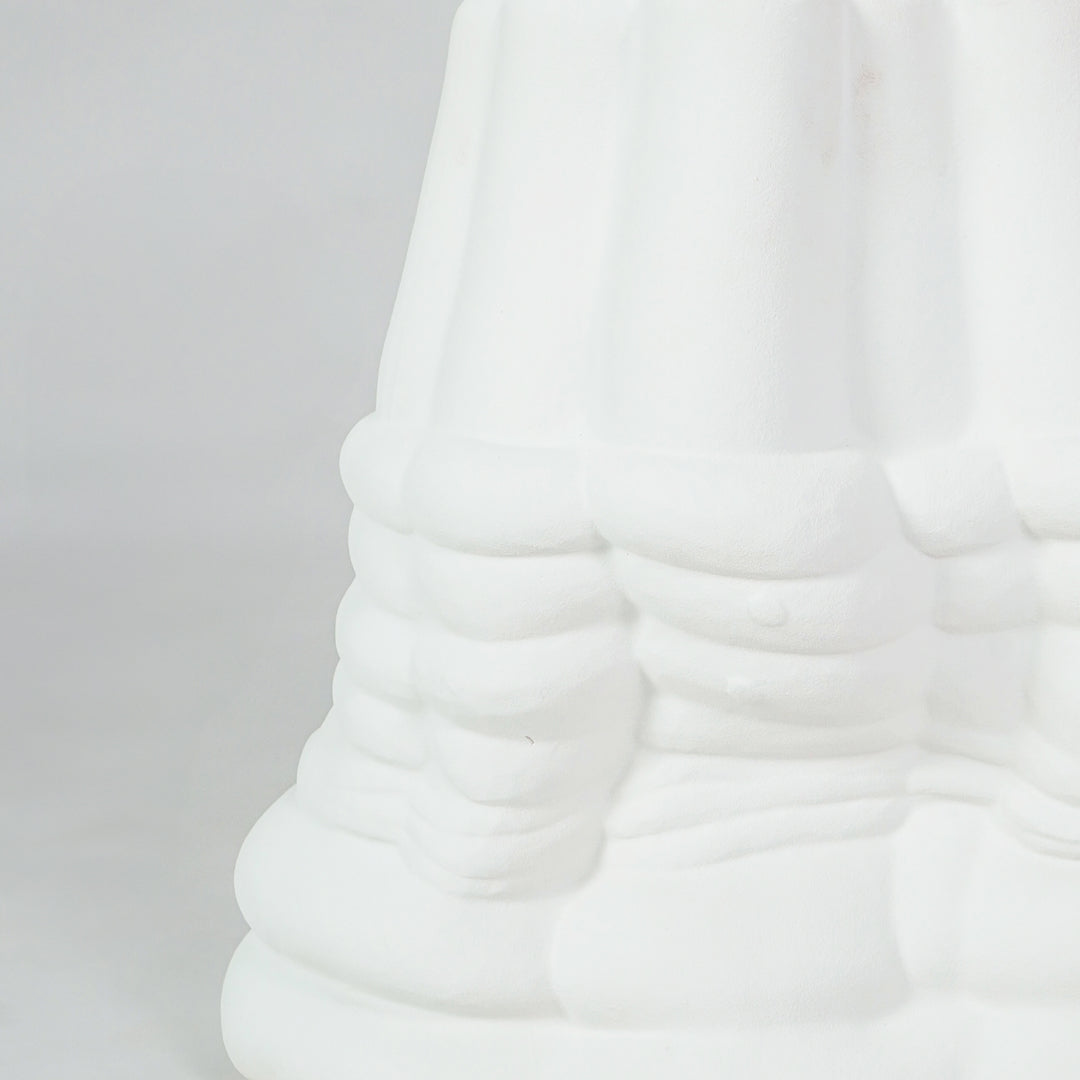 Closeup image of white ceramic abstract decor sculpture for modern living room shelf styling with matte texture display.