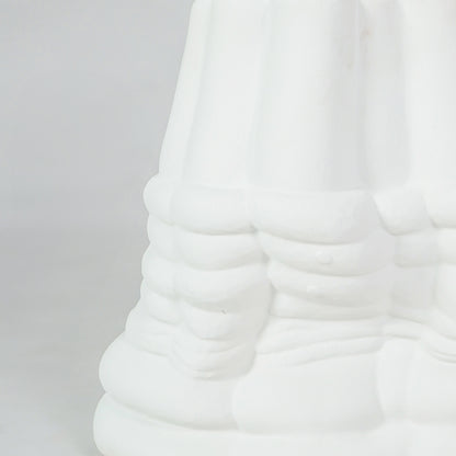 Closeup image of white ceramic abstract decor sculpture for modern living room shelf styling with matte texture display.