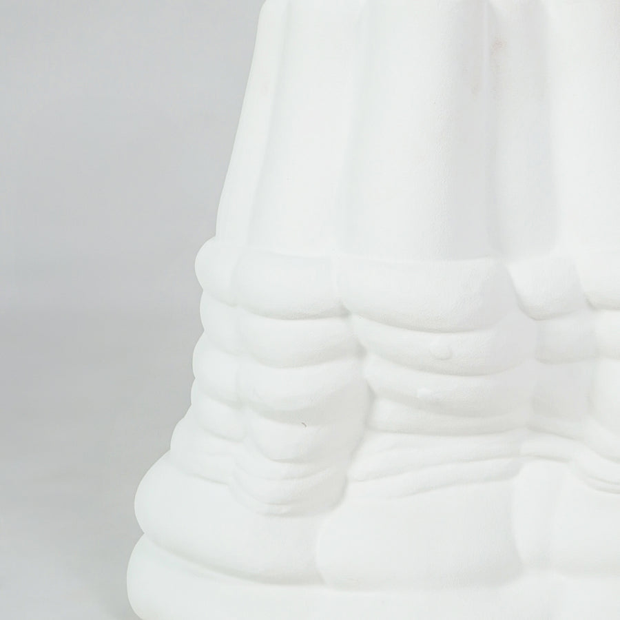 Closeup image of white ceramic abstract decor sculpture for modern living room shelf styling with matte texture display.