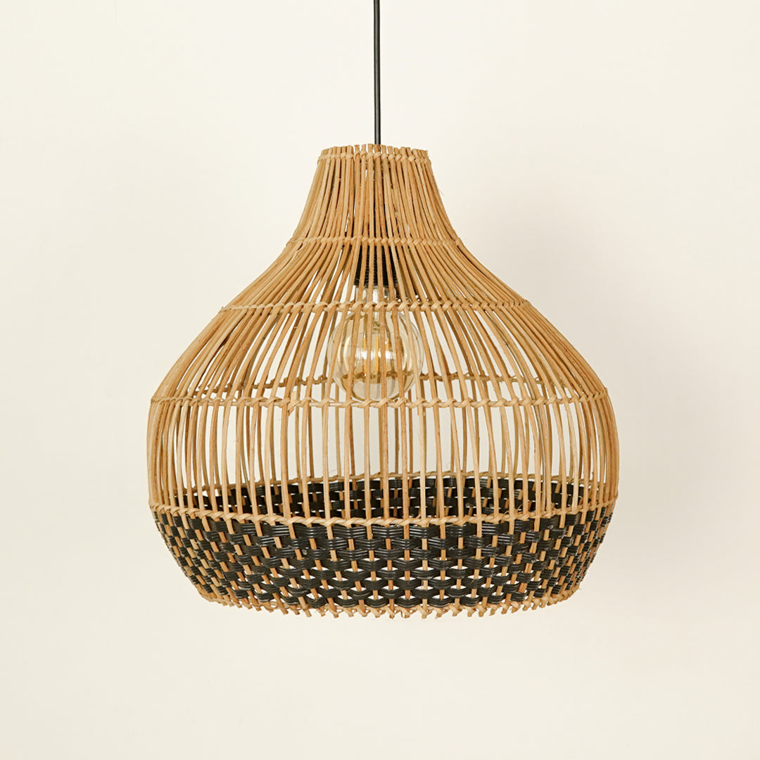 Natural and black rattan pendant light with woven design for stylish dining room ceiling placement.