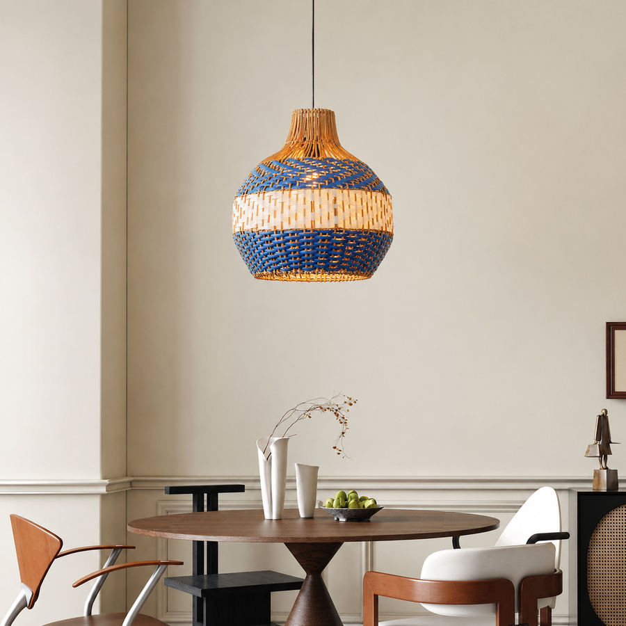 A woven pendant light with a blue and natural beige striped pattern hangs over a round wooden dining table in a modern, neutral-toned dining room.