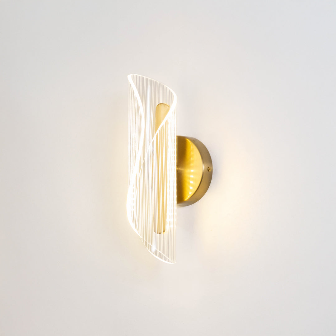 Modern wall light in gold metal finish with sculpted glass design for bedroom or living room decor lighting white background.