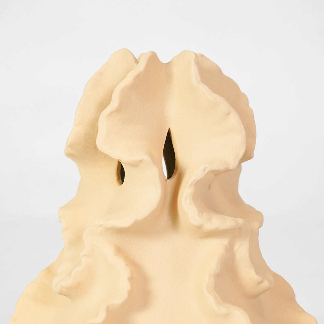 Closeup image of beige ceramic artistic sculpture for modern tabletop decor styling with elegant textured matte finish.
