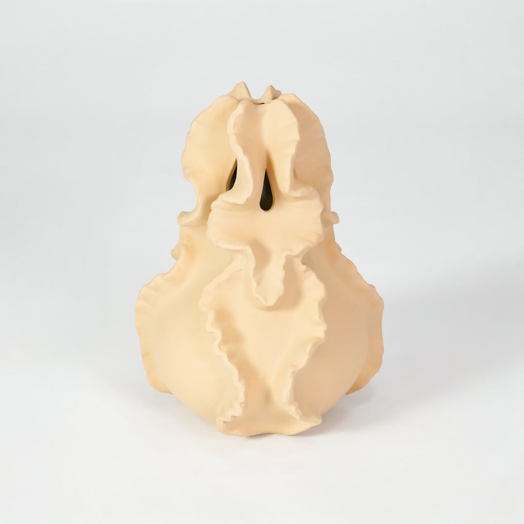 Beige sculptural ceramic vase for modern shelf placement and artistic indoor home decor styling accent piece.