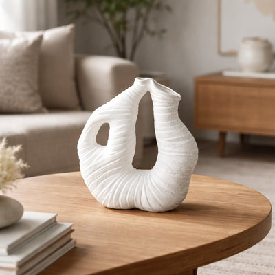 White ceramic abstract sculptural vase with textured organic design perfect for dried flower display on console table and modern home decor.