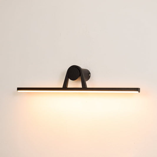 Black metal picture light switched on over white background spreading soft warm glow ideal for gallery wall lighting.