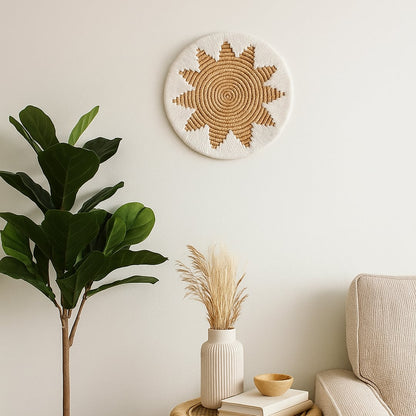 Natural jute and white woven sunburst wall plate decor hanging above a beige sofa with indoor plant styling adding warm organic texture to the room wall.