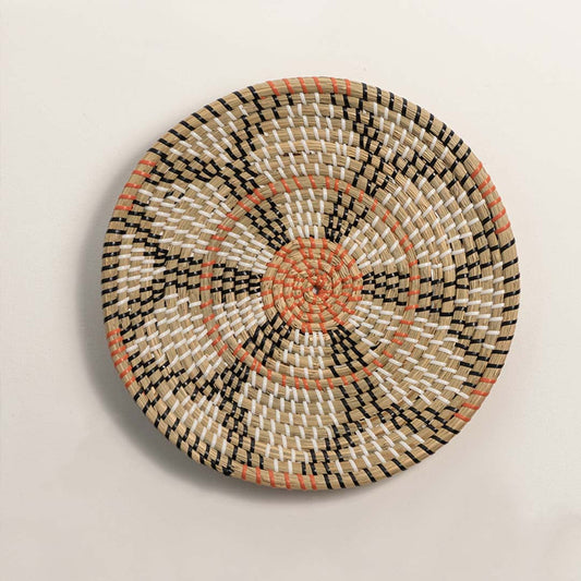 Natural woven decorative wall basket with floral pattern and terracotta accents for elegant wall styling and home decor.