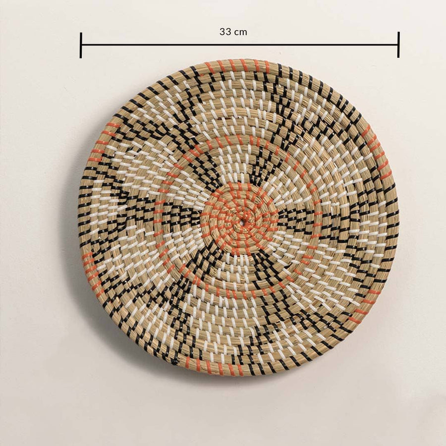 Dimension image of handcrafted natural seagrass wall basket with black and orange geometric floral pattern for boho decor.