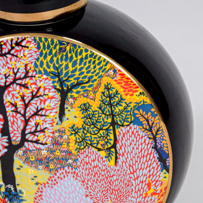 Closeup of round ceramic decorative jar with colorful tree artwork showcasing premium craftsmanship and artistic detailing.