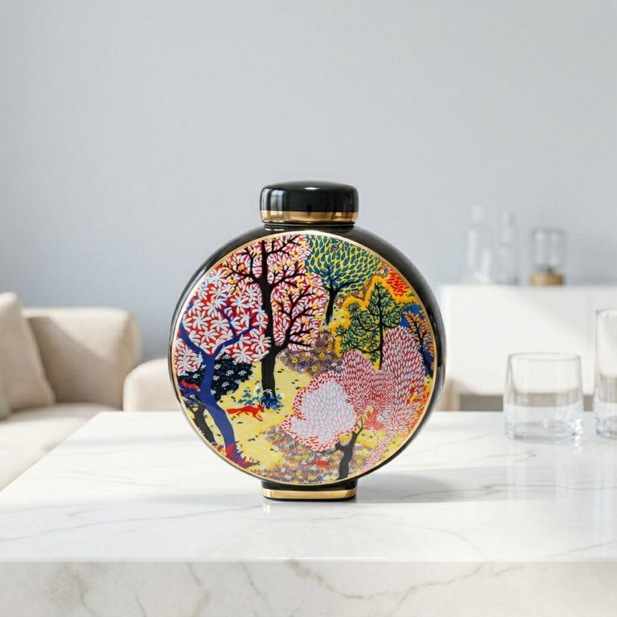 Round ceramic decorative jar with vibrant tree artwork styled on a dining table for contemporary home decor settings.