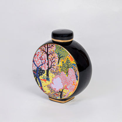 Round ceramic decorative jar with vibrant tree artwork for contemporary shelf styling and modern home decor displays.