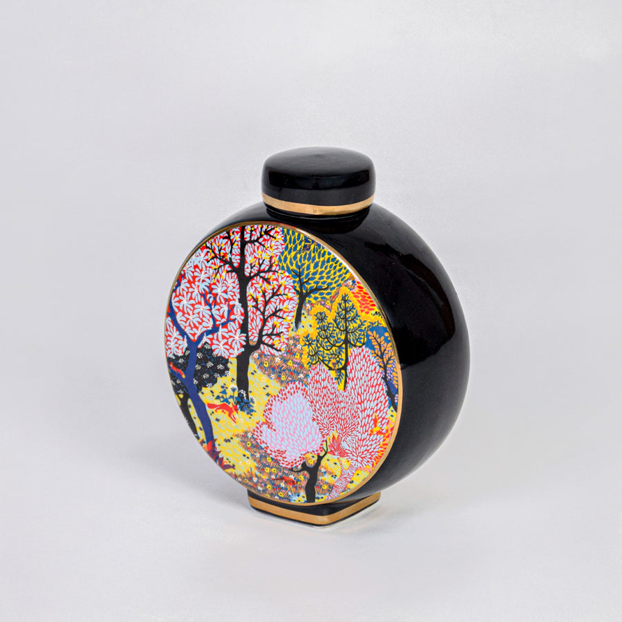 Round ceramic decorative jar with vibrant tree artwork for contemporary shelf styling and modern home decor displays.