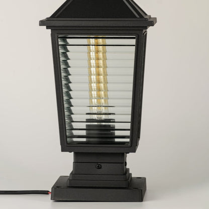 Closeup of black outdoor gate light with ribbed glass panels for elegant modern decor styling use.