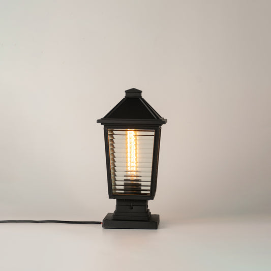 Modern black outdoor gate light with glowing bulb for stylish exterior decor styling use.