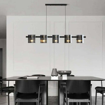 Black metal chandelier with smoked glass shades featured in a modern home setting adding warm ambient glow to the space.