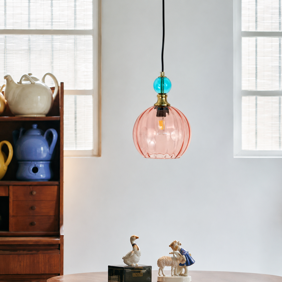 Lifestyle image of danish glass ball chandelier in red and blue for elegant dining room decor styling and modern lighting.
