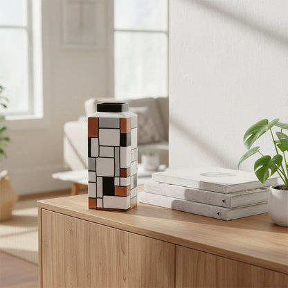 Geometric patterned ceramic decor vase in black white and earthy tones styled on wooden console table for modern living room accent.
