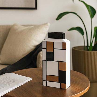 Modern geometric ceramic vase styled in a clean setting highlighting its artistic block pattern design.