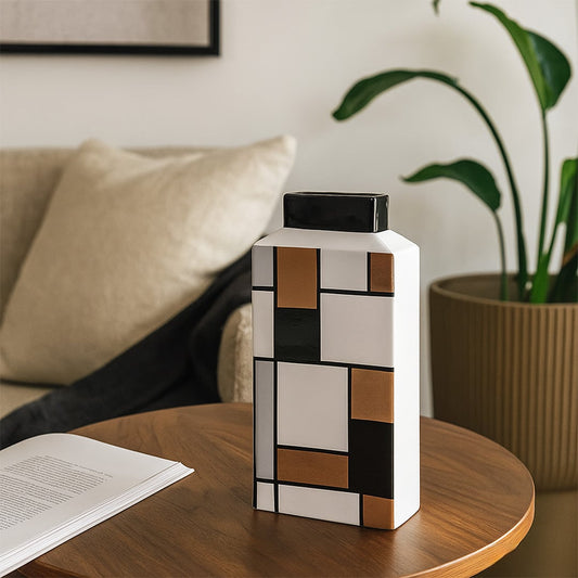 Modern geometric ceramic vase styled in a clean setting highlighting its artistic block pattern design.