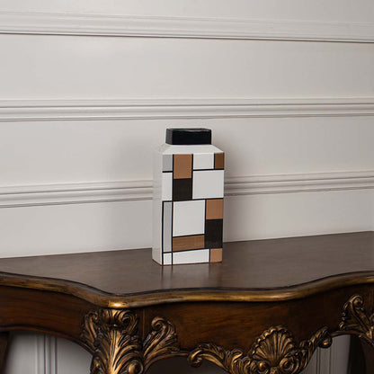 Geometric ceramic vase displayed on a white background featuring a structured modern block pattern.