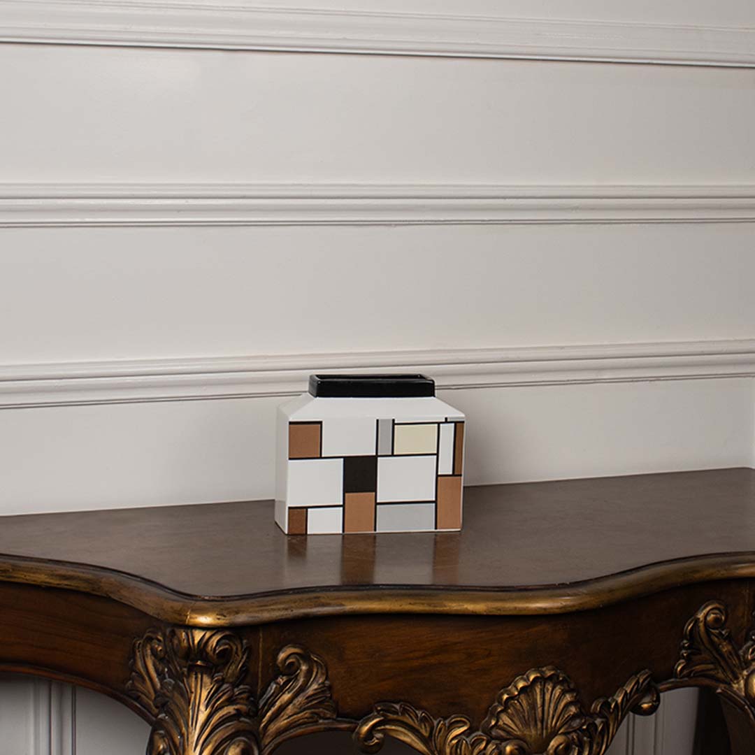 Contemporary ceramic vase with geometric block art placed against a white background for a clear product presentation.