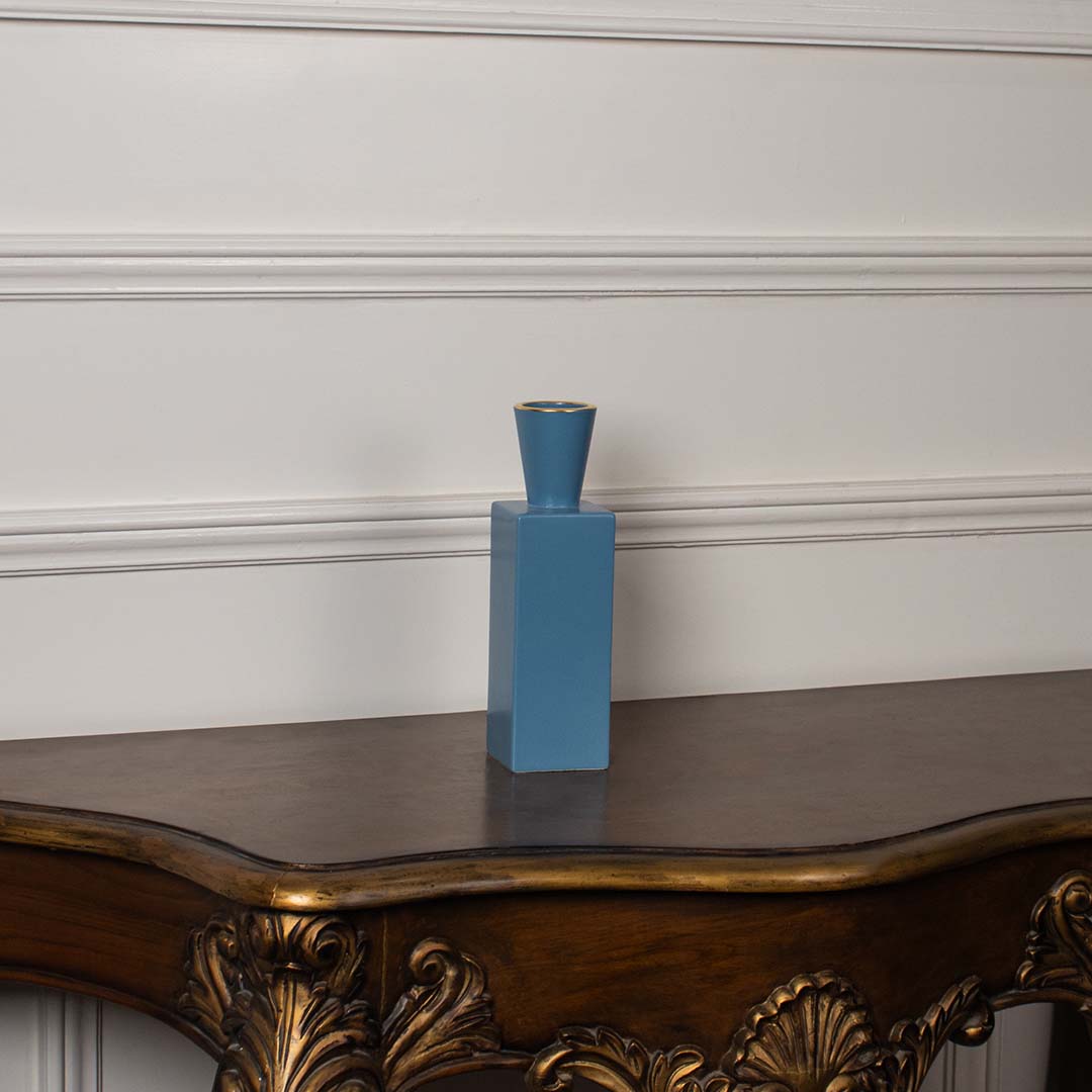 A blue rectangular ceramic vase with a tapered top displayed on a clean white background  showcasing its simple modern silhouette clearly.