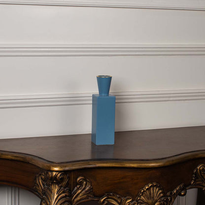 A blue rectangular ceramic vase with a tapered top displayed on a clean white background  showcasing its simple modern silhouette clearly.