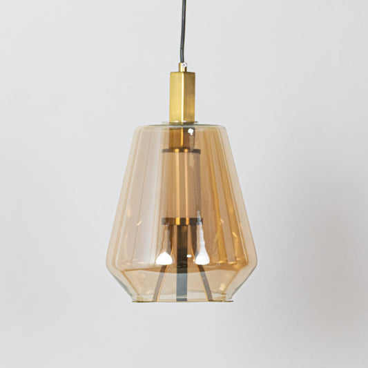 An amber glass pendant light off showing the faceted amber glass shade and gold metal details clearly against a plain white background.