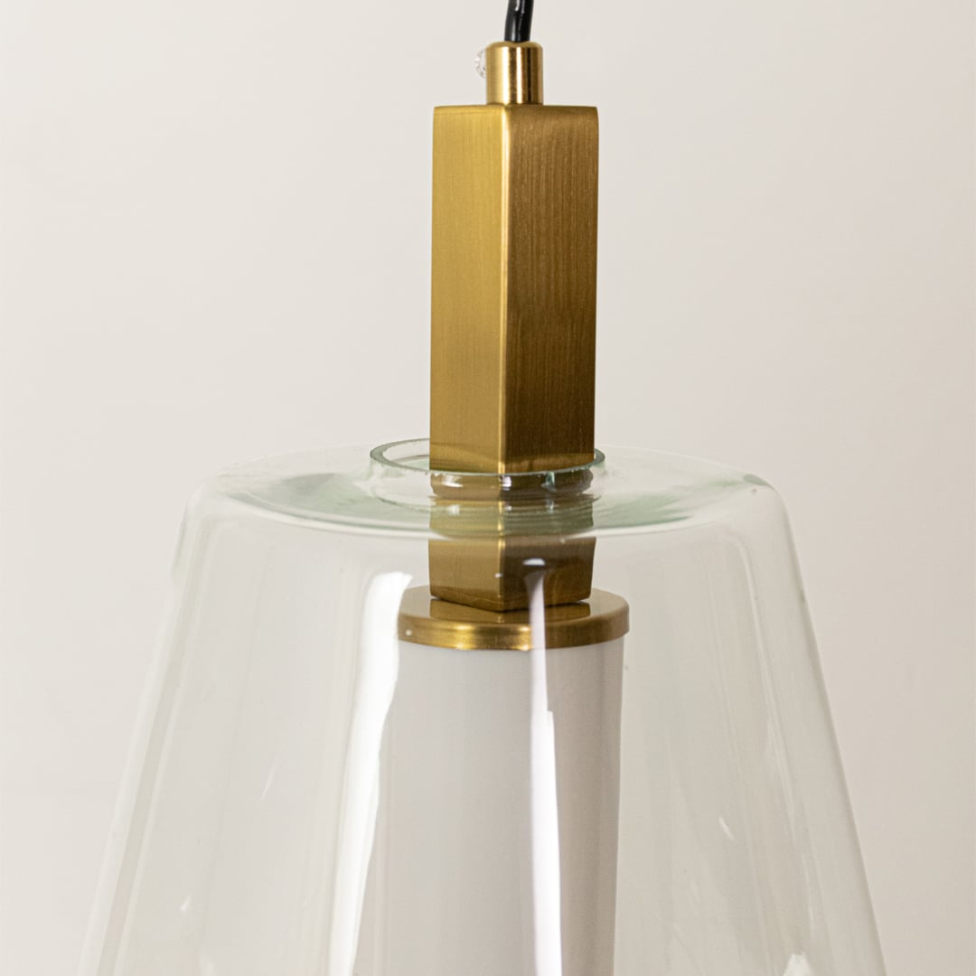 Closeup of clear glass and gold metal pendant light highlighting premium finish and craftsmanship.
