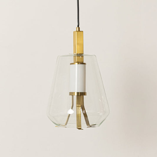 A contemporary glass pendant light photographed on a simple white background featuring its clear faceted shade and gold structure with the light turned off.