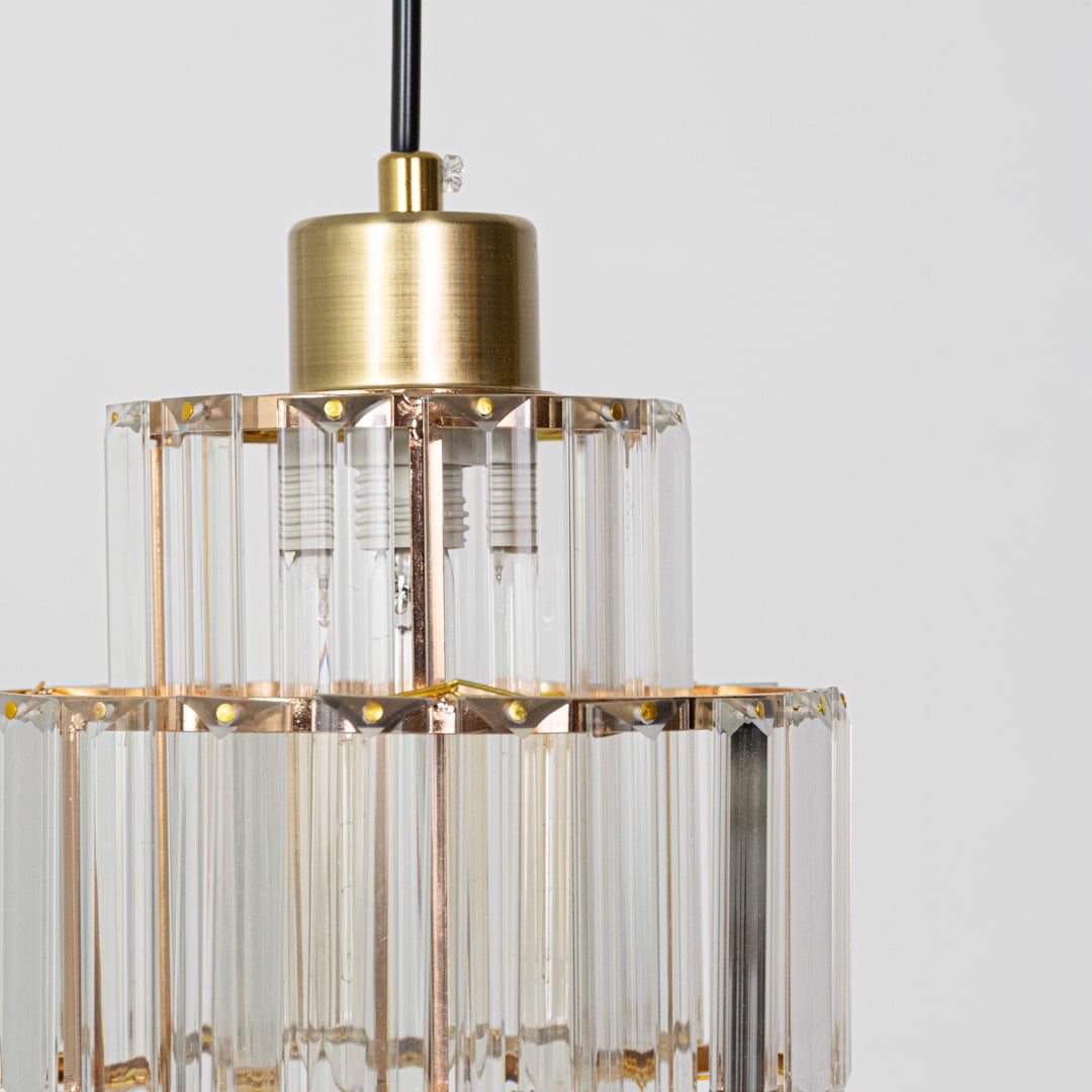 Closeup of crystal and gold metal pendant light highlighting premium detailing and craftsmanship.